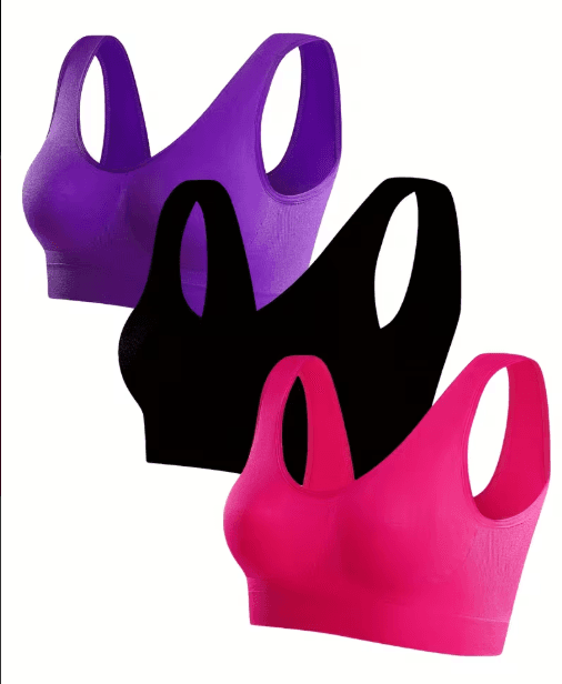 Conjunto de ropa deportiva/de mujer en bolsa plástica: prenda principal de color negro con detalles rosa fucsia y morado, aparentemente de material elástico tipo lycra/spandex.
